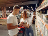 Young couple selecting food in market