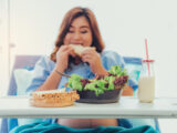 Pregnant woman eating bread, milk, fruits and vegetables, from relatives to visit.