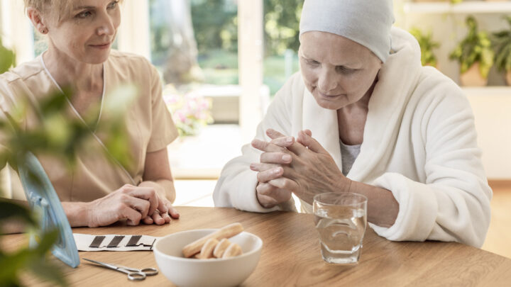 Psychologist and patient sitting together at a table in a nursing home