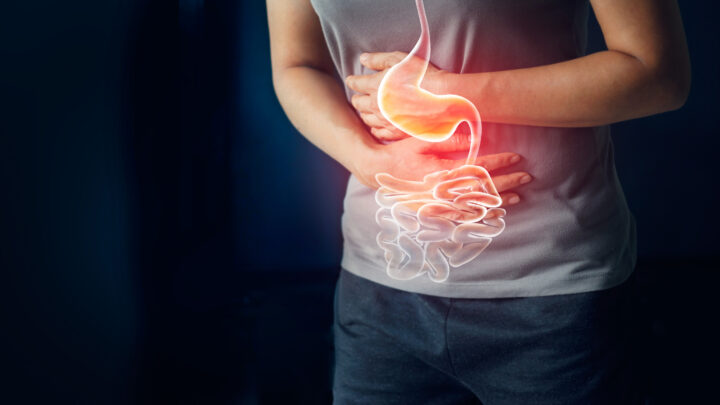 Woman touching stomach painful suffering from stomachache causes of menstruation period, gastric ulcer, appendicitis or gastrointestinal system disease. Healthcare and health insurance concept
